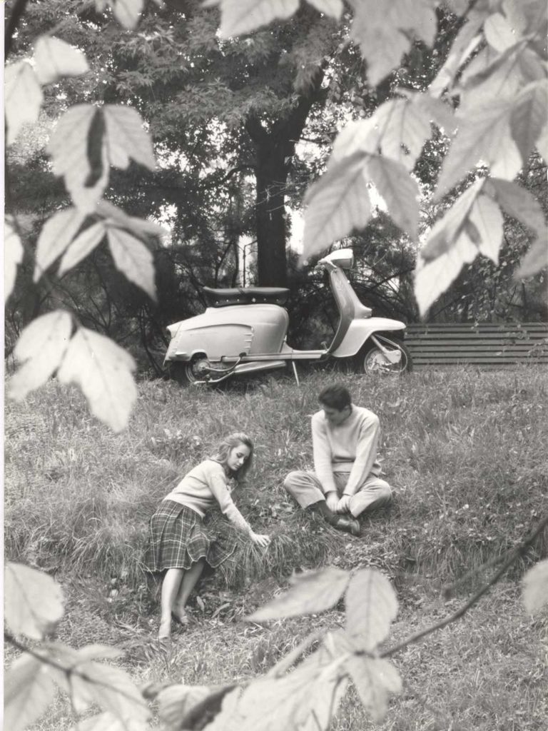 1964 Man and woman with Lambretta scooter in the park