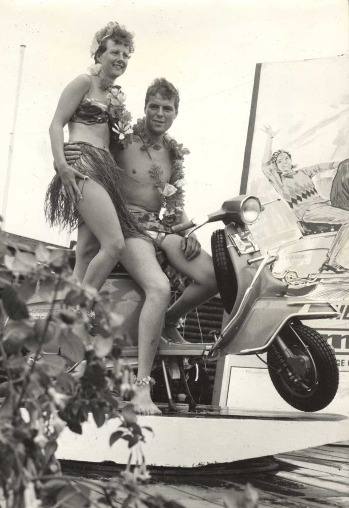 1964 man and woman on Lambretta scooter with Hawaii clothes