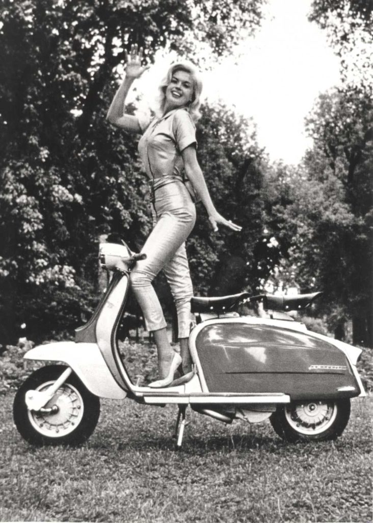 Jayne Mansfield standing on Lambretta scooter